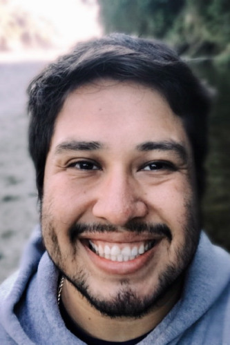 Argenis Hurtado Moreno who has short brown hair, a mustache and short beard, and is wearing a gray sweatshirt
