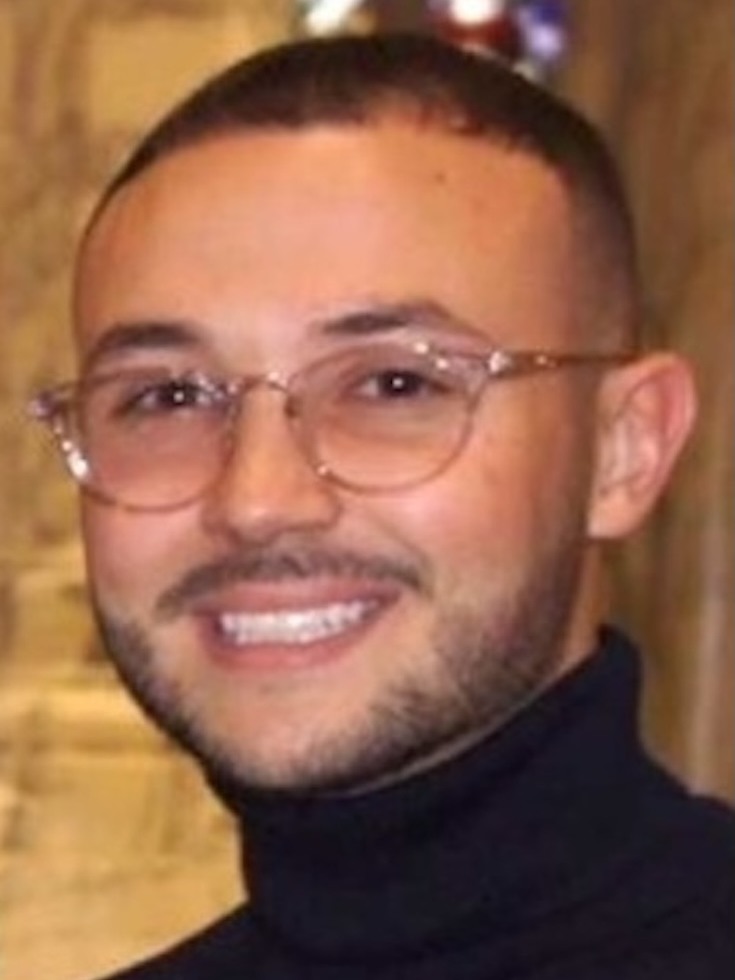 Photo of Corey Silvia wearing round glasses and a black turtleneck