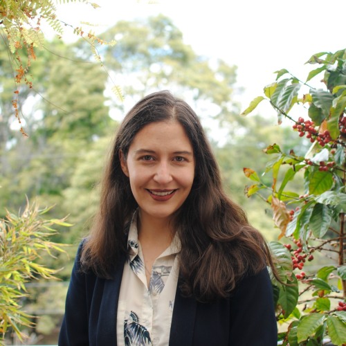 María Medellín Esguerra smiling outside surrounded by greenery