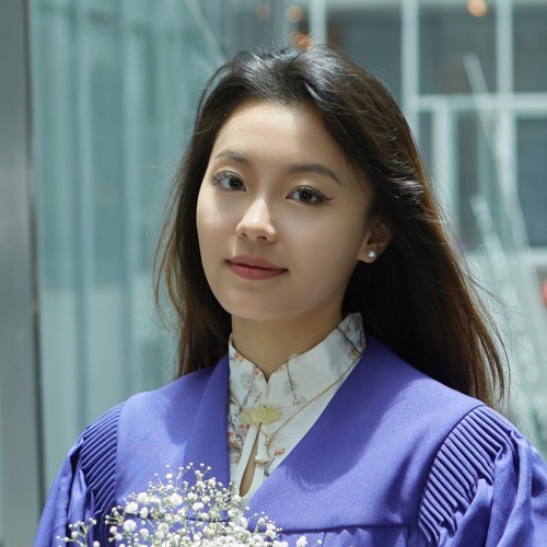 Zixi Li holding flowers and smiling.