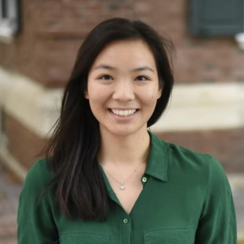 Katie Trinh smiling at the camera in a green shirt.