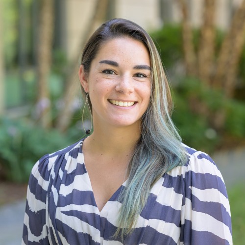 Photo of Samantha Brady wearing striped shirt in front of blurred outdoor background