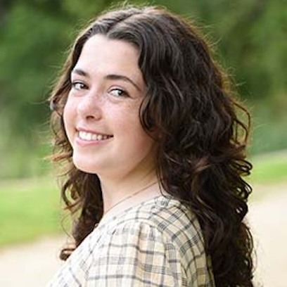 Photo of Belen Sanchez Mathews wearing a beige blouse in an outdoor background