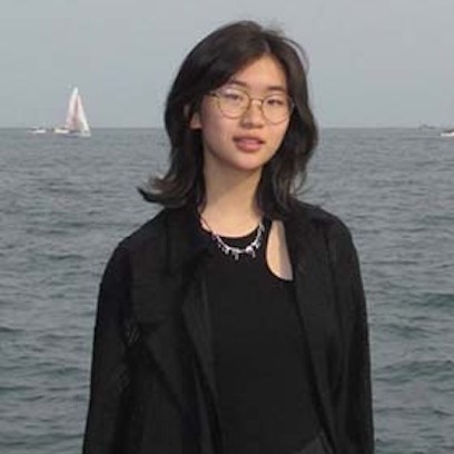 Photo of Cunyan Ma wearing black top and standing in front of ocean background
