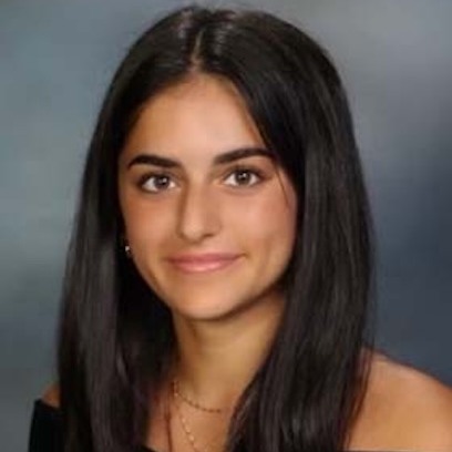 Photo of Lela Miller wearing black top against gray background