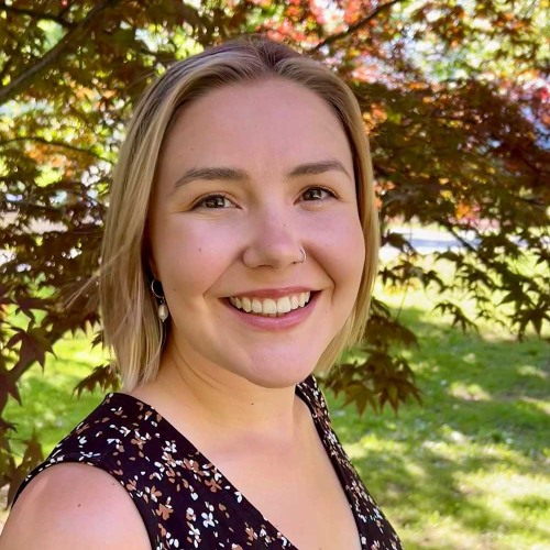 Sarah Hodgman wearing a black print tank top with a foliage background