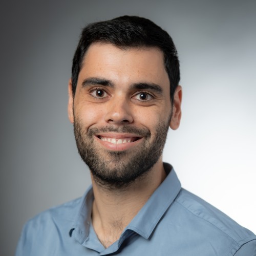 Israel Eruchimovitch wearing blue polo shirt on gray background